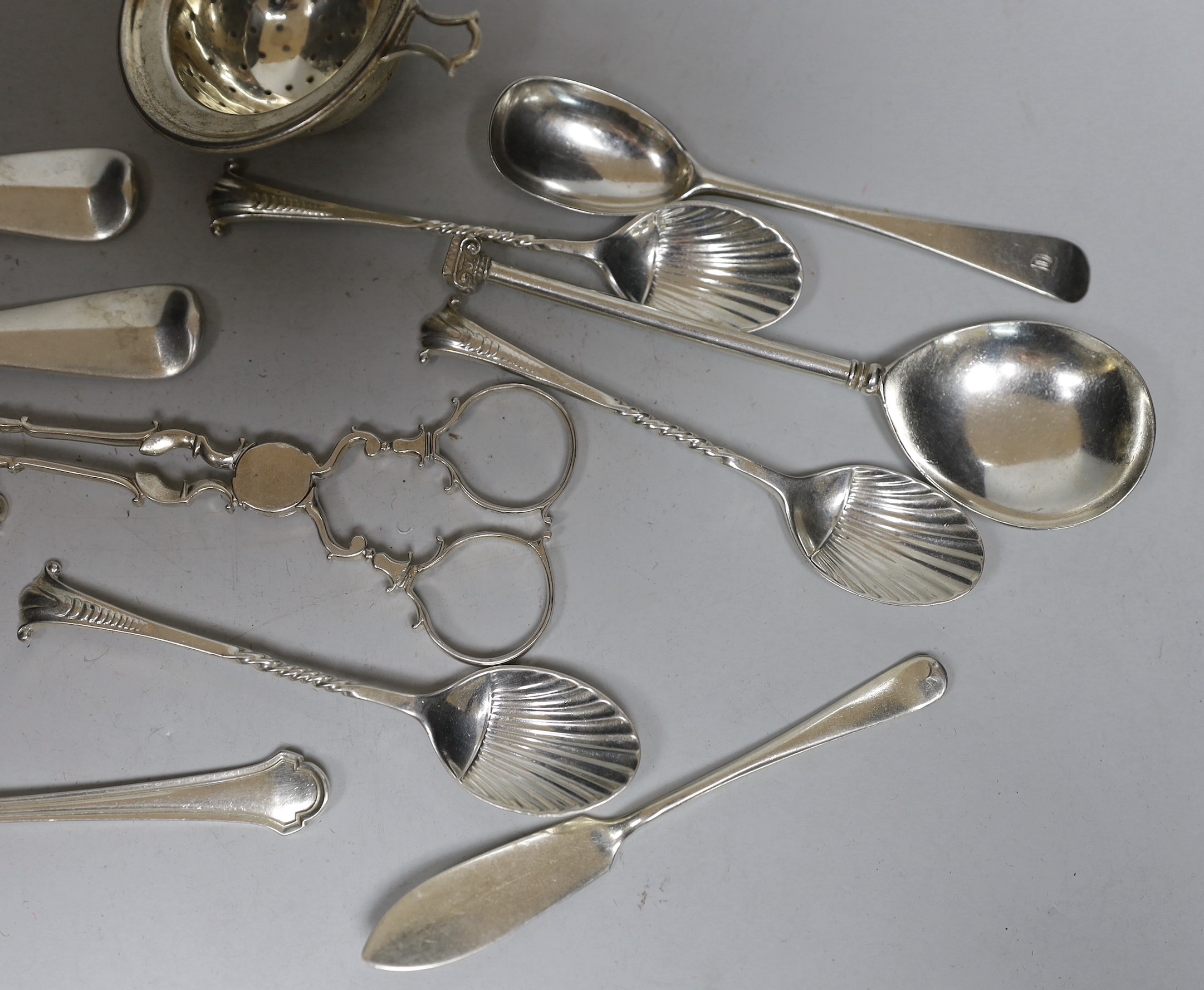 A silver tea strainer and a small collection of assorted 20th century and earlier silver cutlery, various dates and makers, including a pair of mid 18th century sugar nips, 9.7oz.